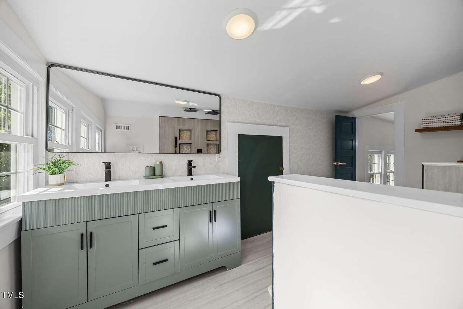 523 East Main Street Haw River, NC 27258 - Photo 16 of 25 a spacious bathroom with a granite countertop sink mirror and toilet