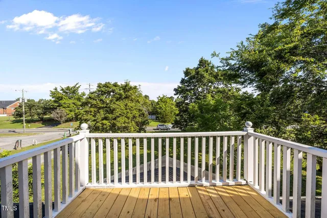 a view of balcony with wooden floor and fence