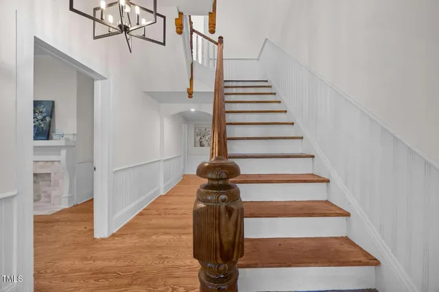 a view of entryway and hall with wooden floor