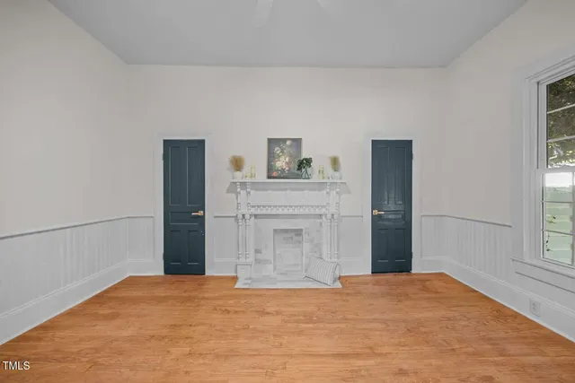 a view of empty room with cabinet and window