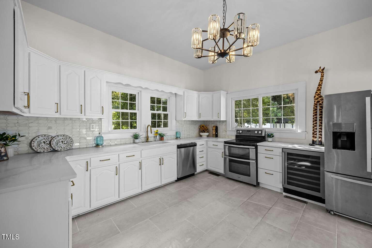 523 East Main Street Haw River, NC 27258 - Photo 7 of 25 a kitchen with a stove a sink and a refrigerator