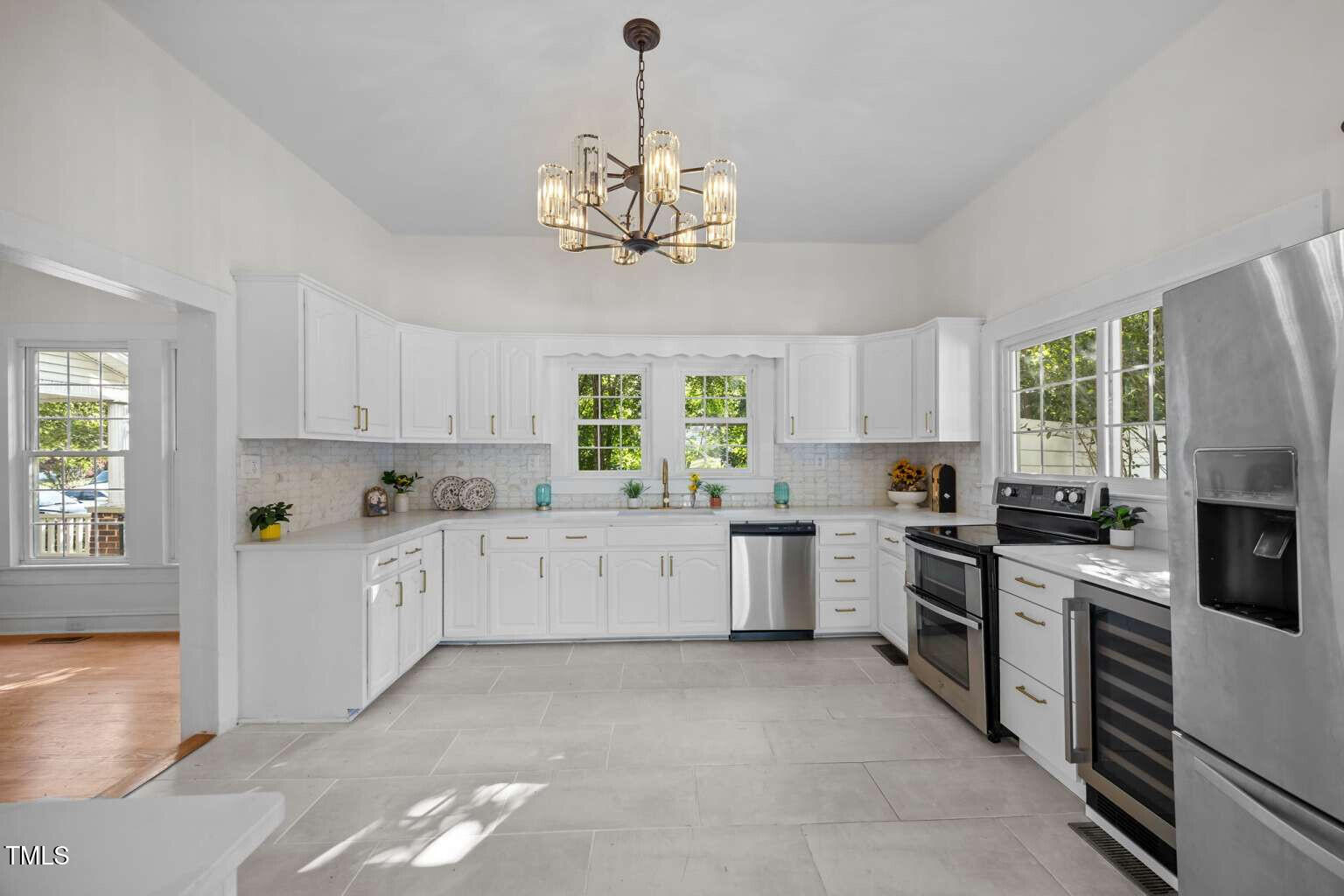 523 East Main Street Haw River, NC 27258 - Photo 8 of 25 a large kitchen with a stove top oven a sink a window and dining table
