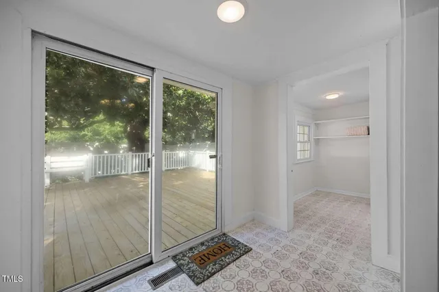 a view of entryway with a floor to ceiling window and wooden floor