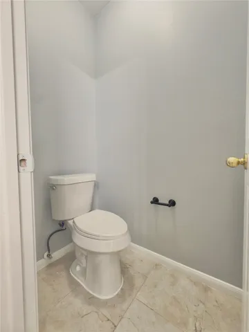a white toilet sitting next to a white sink