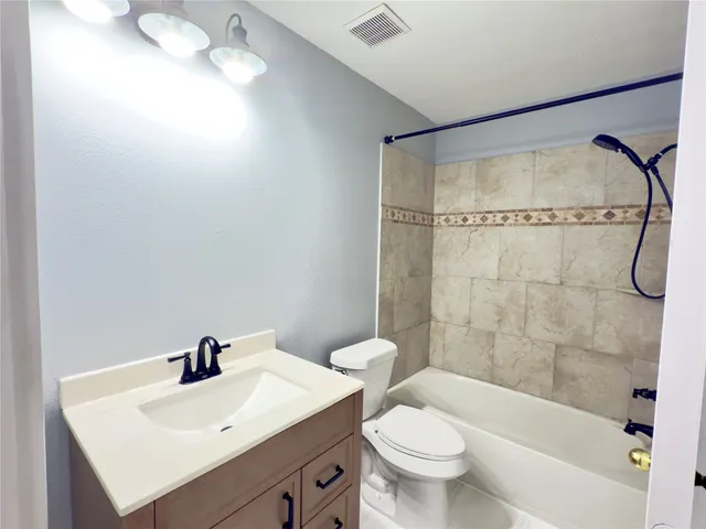 a bathroom with a sink mirror toilet and bathtub