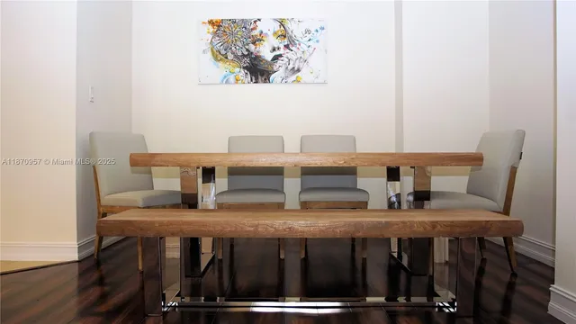 a kitchen with a table chairs and a refrigerator