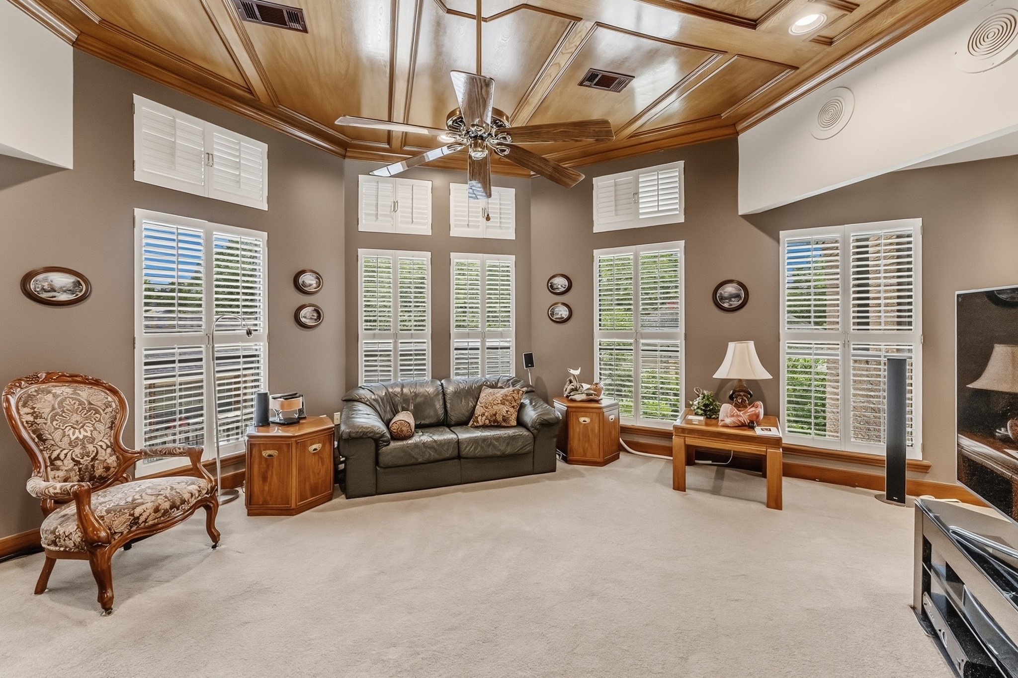6047 Spring Creek Lane Spring, TX 77379 - Photo 22 of 50 With its regal wood lined ceiling and expansive layout, the upstairs game room offers a gathering space that feels both elevated and welcoming. A wall of windows dressed with plantation shutters carried throughout much of the home fills the room with natural light, while built in speakers and recessed lighting shared throughout the main living areas add comfort and convenience.