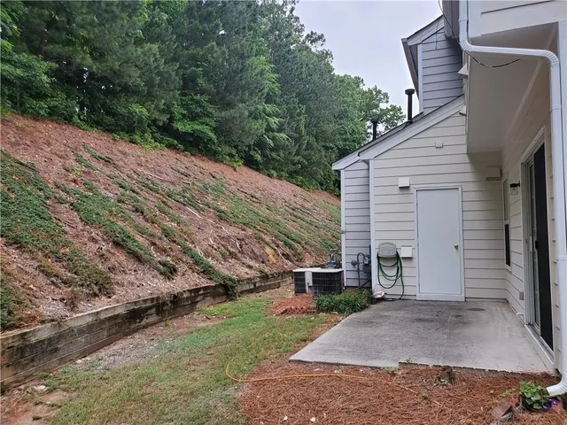 a view of a house with a door and a tree