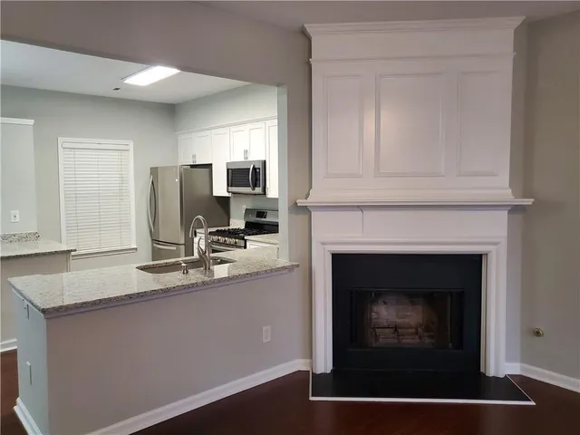 a kitchen with kitchen island a sink stainless steel appliances and cabinets