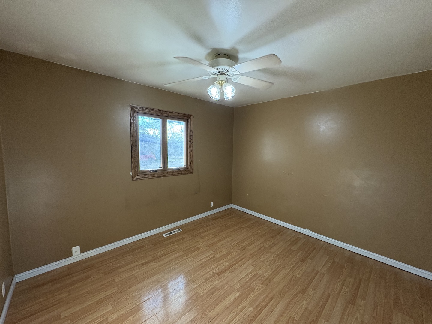 411 Phyllis Avenue Rochelle, IL 61068 - Photo 10 of 26 wooden floor in an empty room with a window
