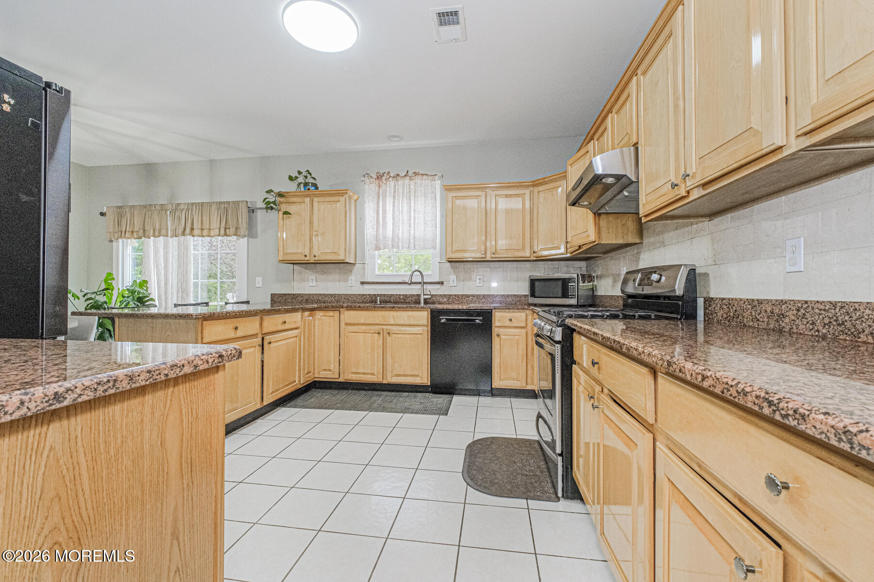 315 Wedgewood Road Morganville, NJ 07751 - Photo 15 of 37 a kitchen with a sink white cabinets and appliances