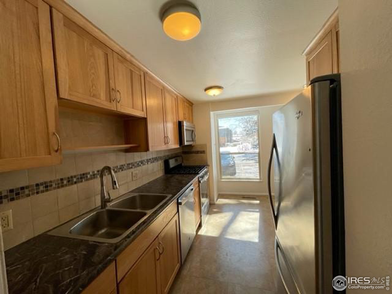 1187 Bear Mountain Drive, Unit A Boulder, CO 80305 - Photo 11 of 26 a kitchen with stainless steel appliances granite countertop a sink a stove and a refrigerator