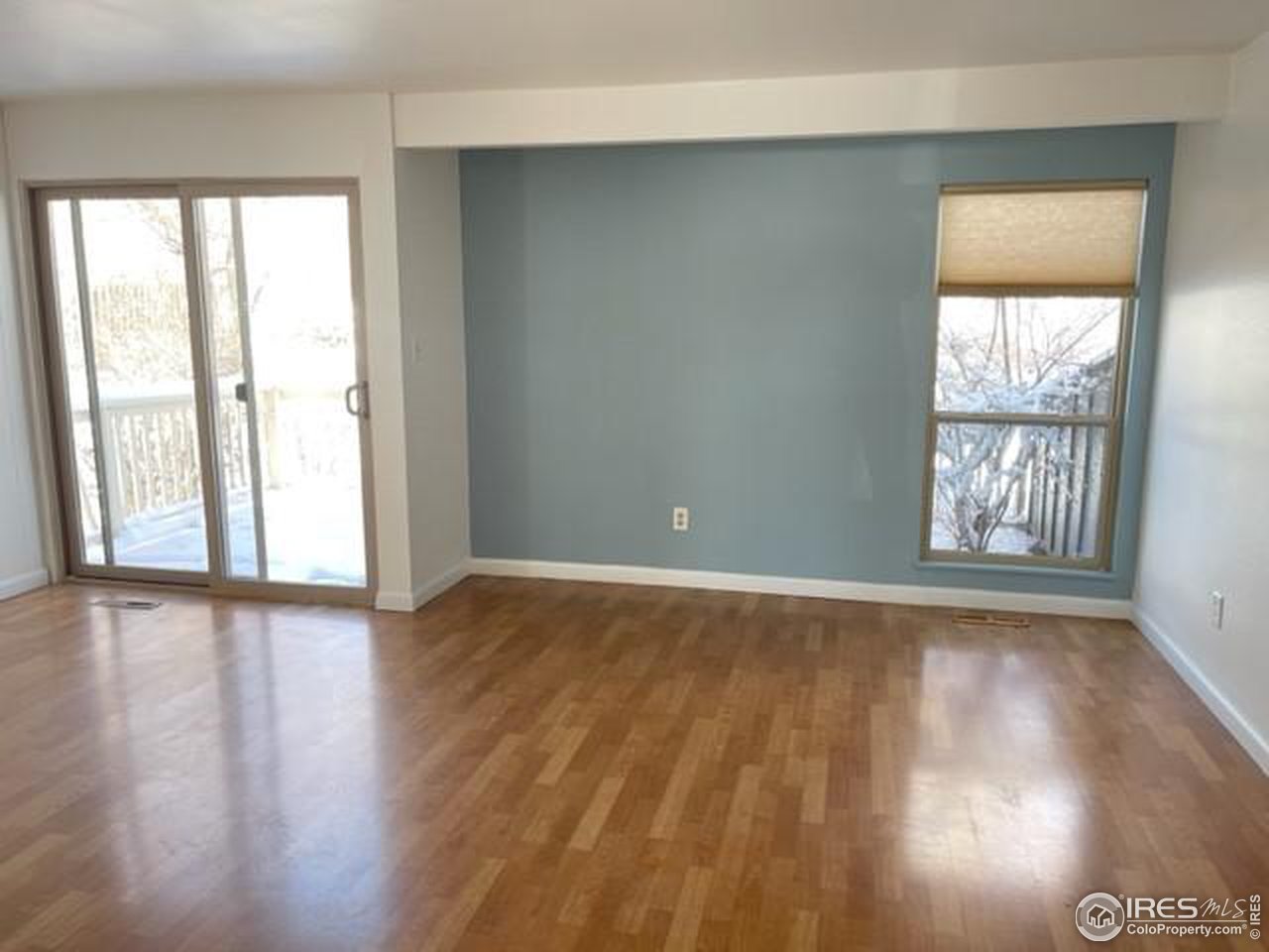 1187 Bear Mountain Drive, Unit A Boulder, CO 80305 - Photo 12 of 26 an empty room with wooden floor and windows