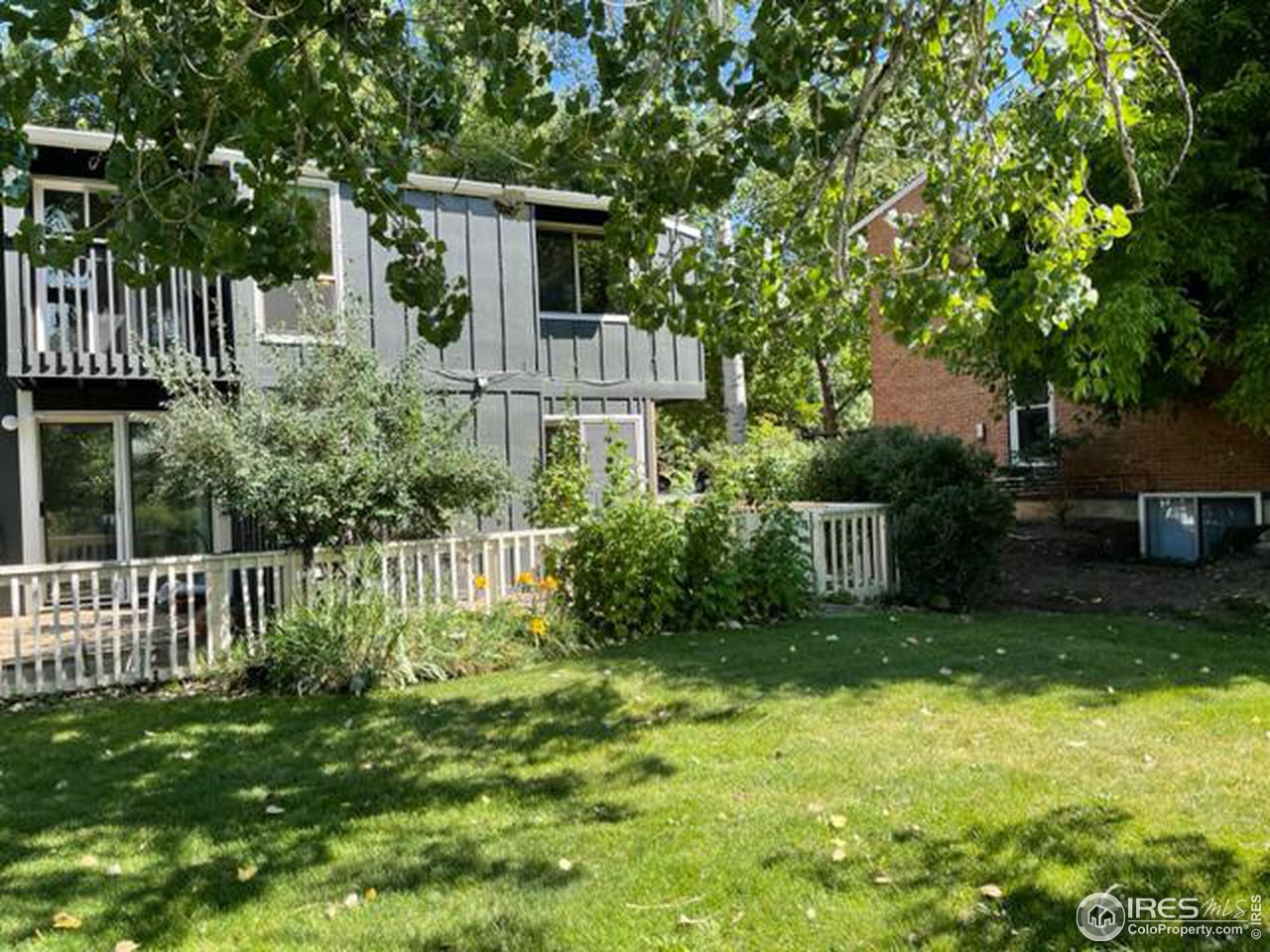 1187 Bear Mountain Drive, Unit A Boulder, CO 80305 - Photo 2 of 26 a view of a house with a yard and plants