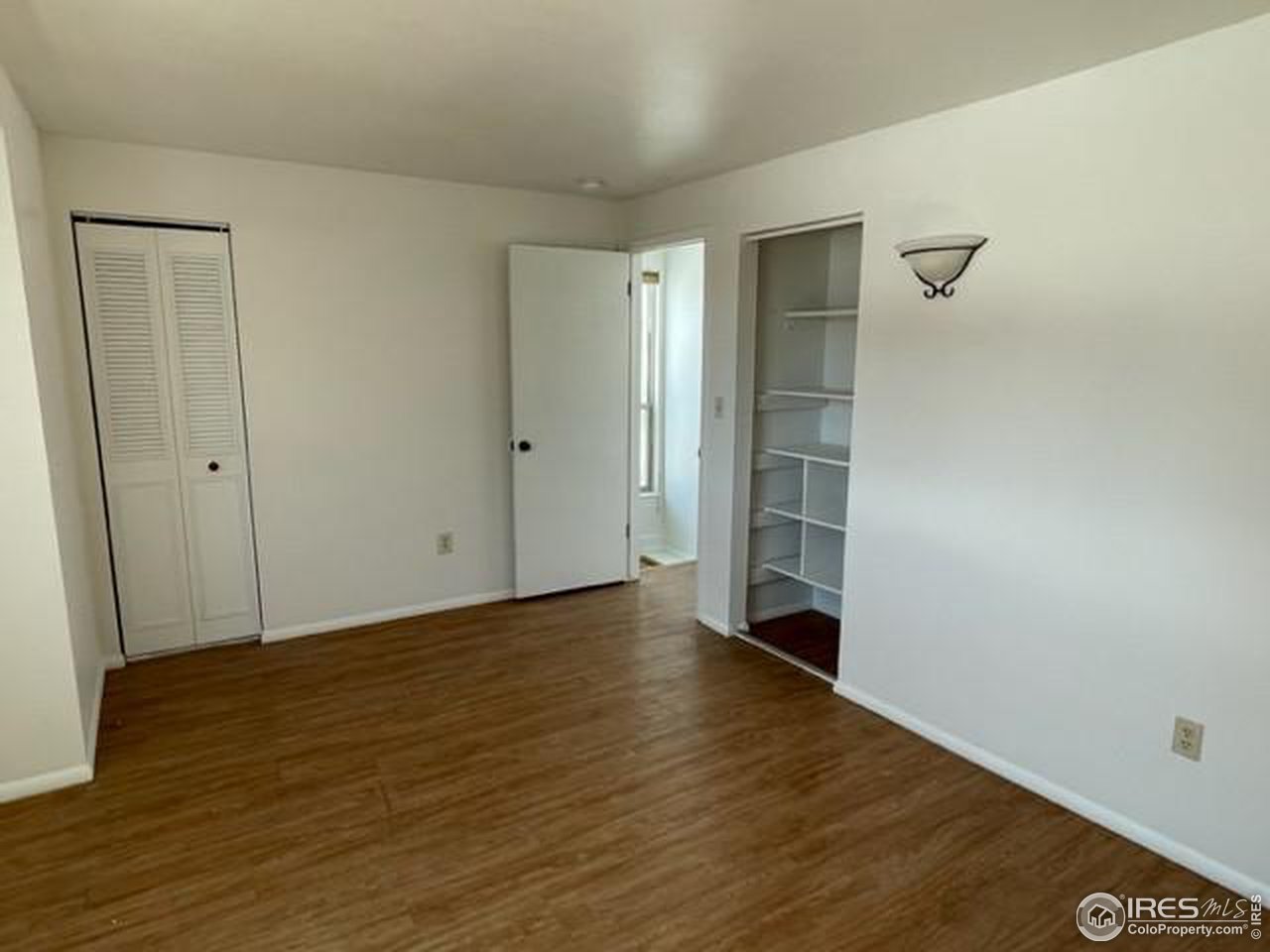 1187 Bear Mountain Drive, Unit A Boulder, CO 80305 - Photo 22 of 26 a view of an empty room with wooden floor and closet