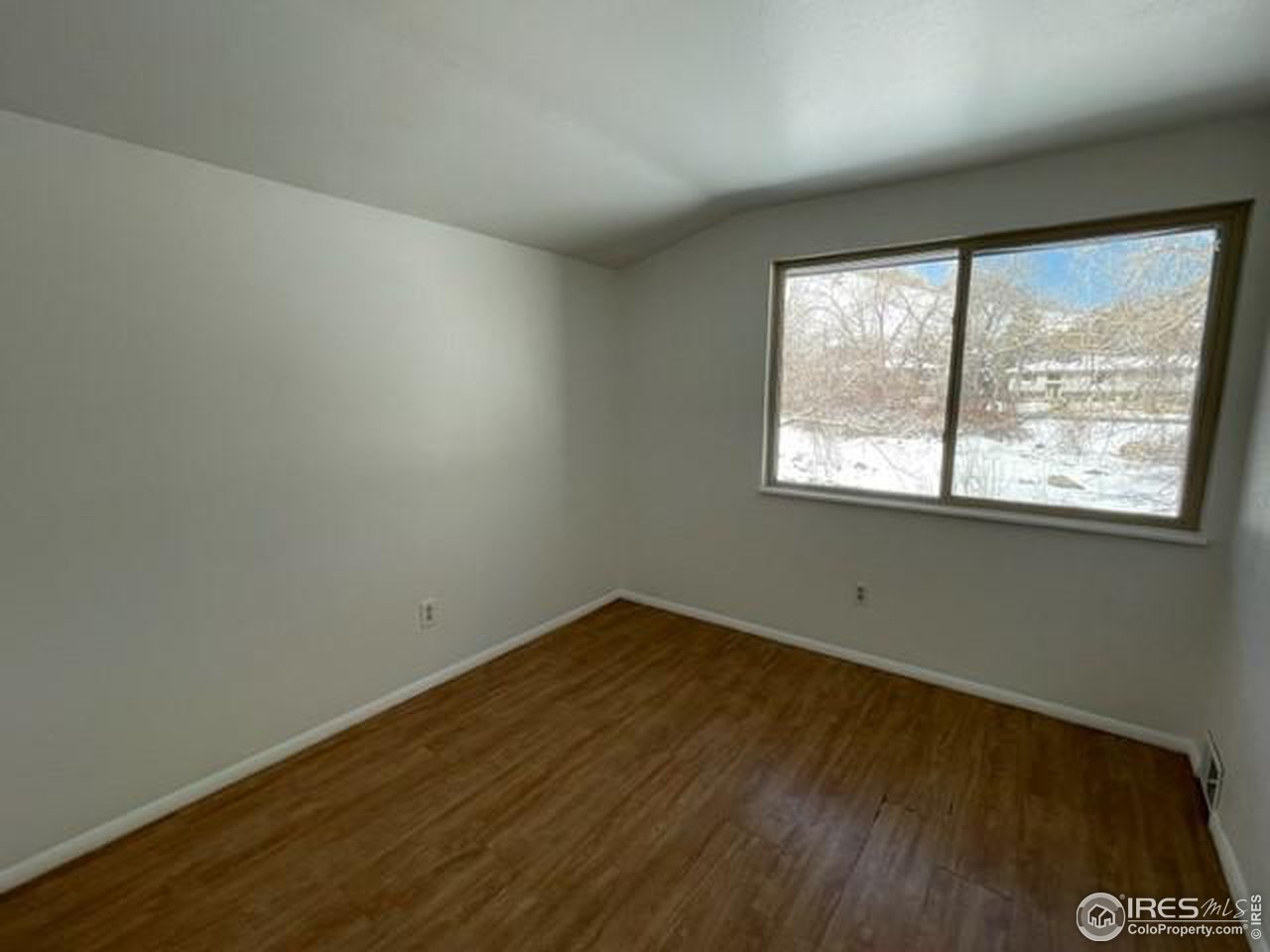 1187 Bear Mountain Drive, Unit A Boulder, CO 80305 - Photo 25 of 26 an empty room with wooden floor and windows