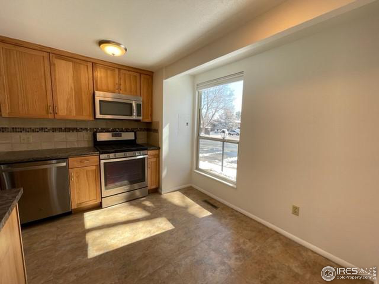 1187 Bear Mountain Drive, Unit A Boulder, CO 80305 - Photo 6 of 26 a kitchen with sink a microwave and cabinets