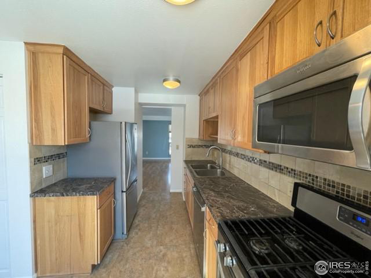1187 Bear Mountain Drive, Unit A Boulder, CO 80305 - Photo 9 of 26 a kitchen with stainless steel appliances granite countertop a stove and a microwave