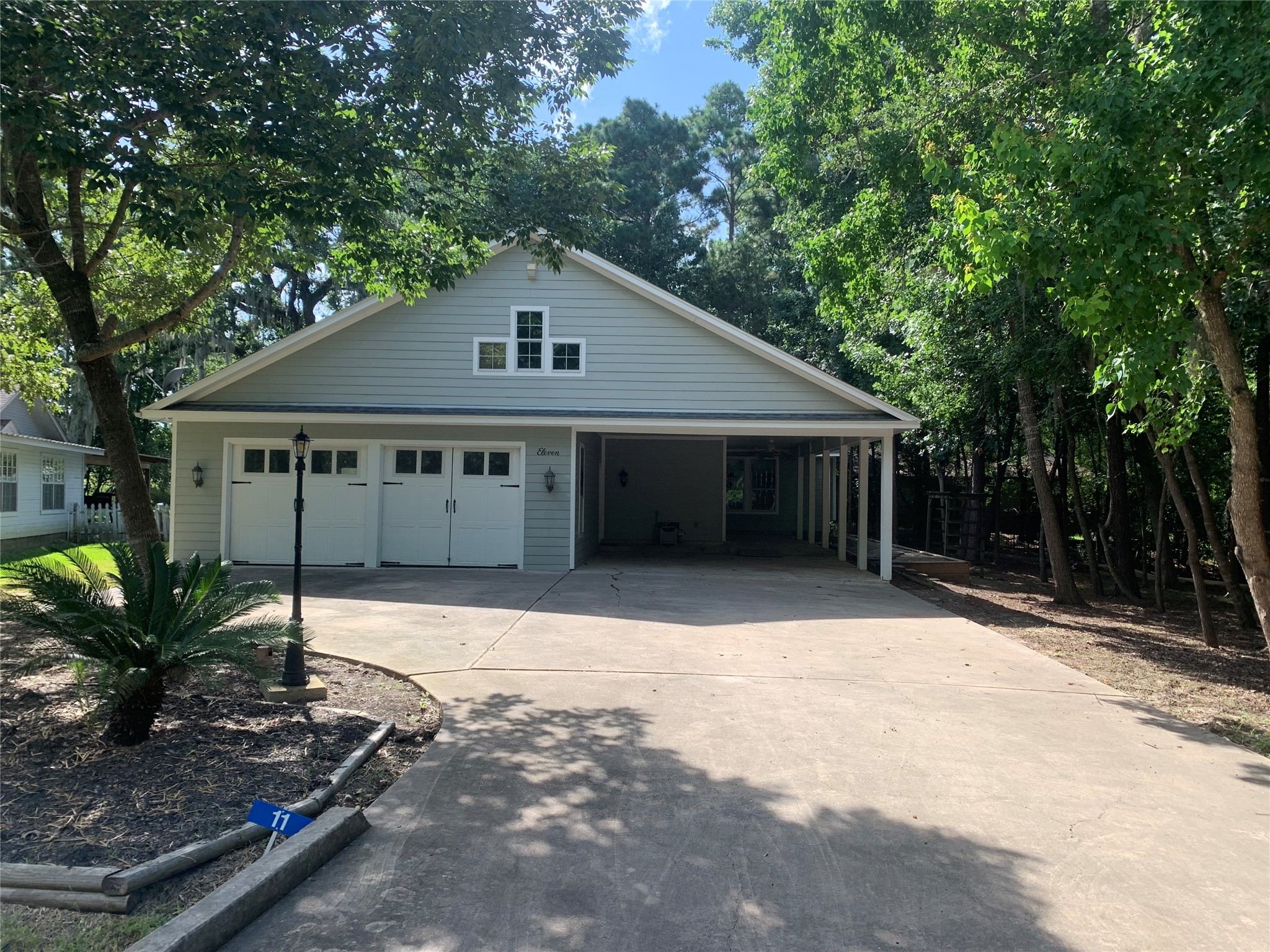 Front entry to the home with a 2 car garage, and two covered parking spaces