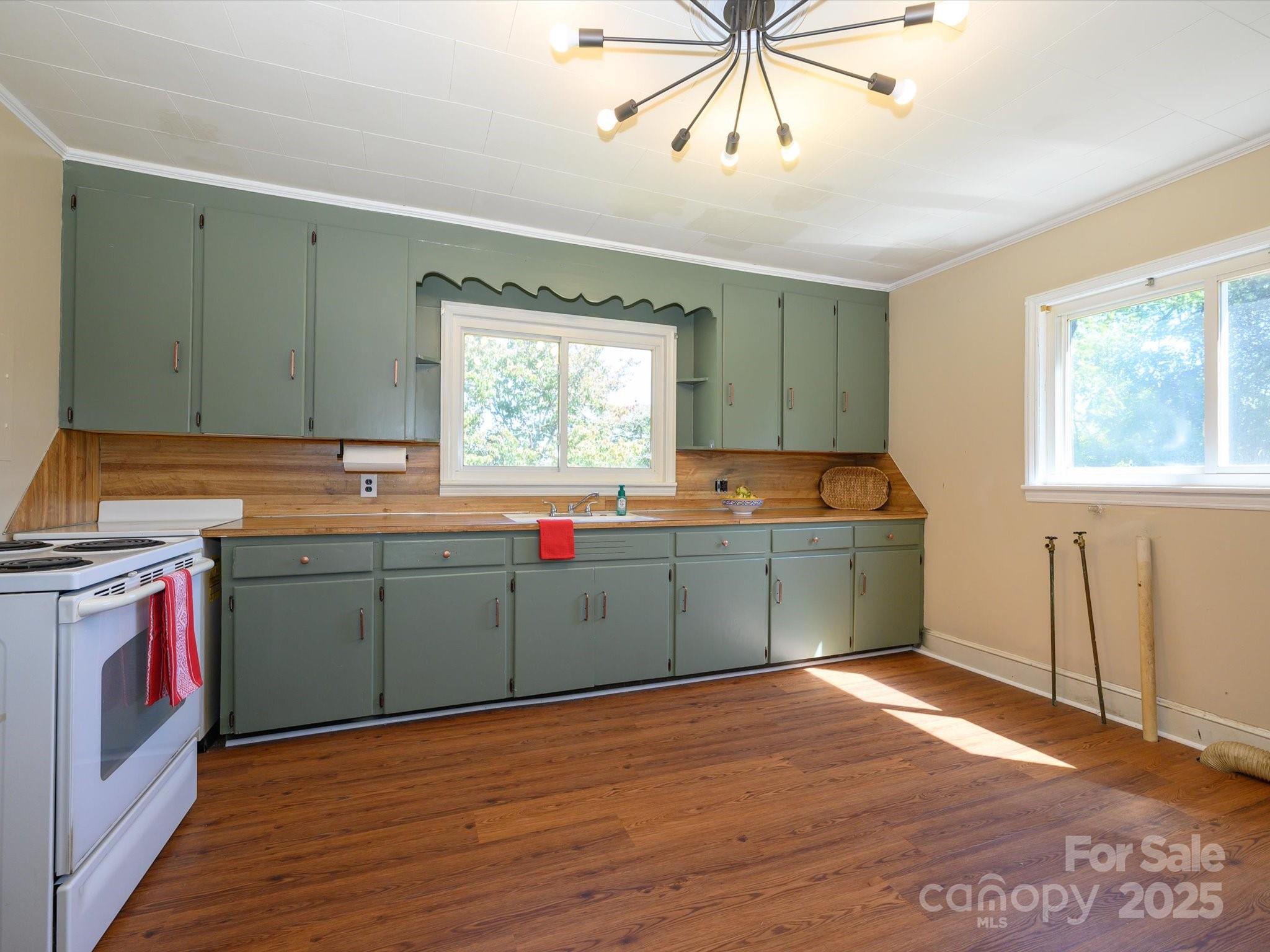 7022 White Store Road Marshville, NC 28103 - Photo 12 of 26 a kitchen with granite countertop a sink cabinets and wooden floor