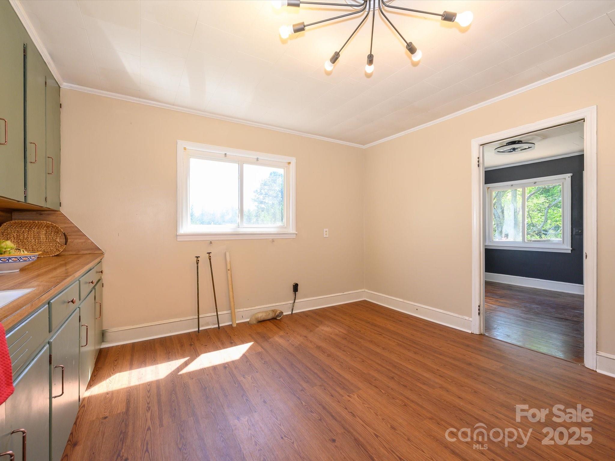 7022 White Store Road Marshville, NC 28103 - Photo 15 of 26 an empty room with wooden floor and windows