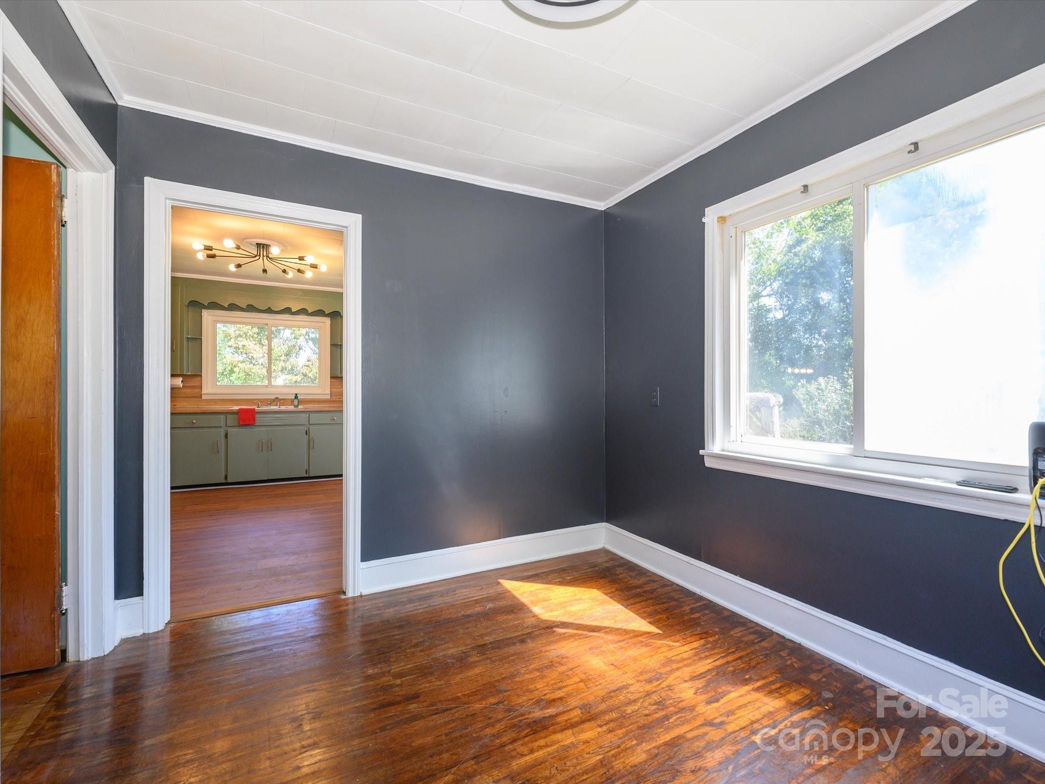 7022 White Store Road Marshville, NC 28103 - Photo 17 of 26 a view of empty room with wooden floor and fan
