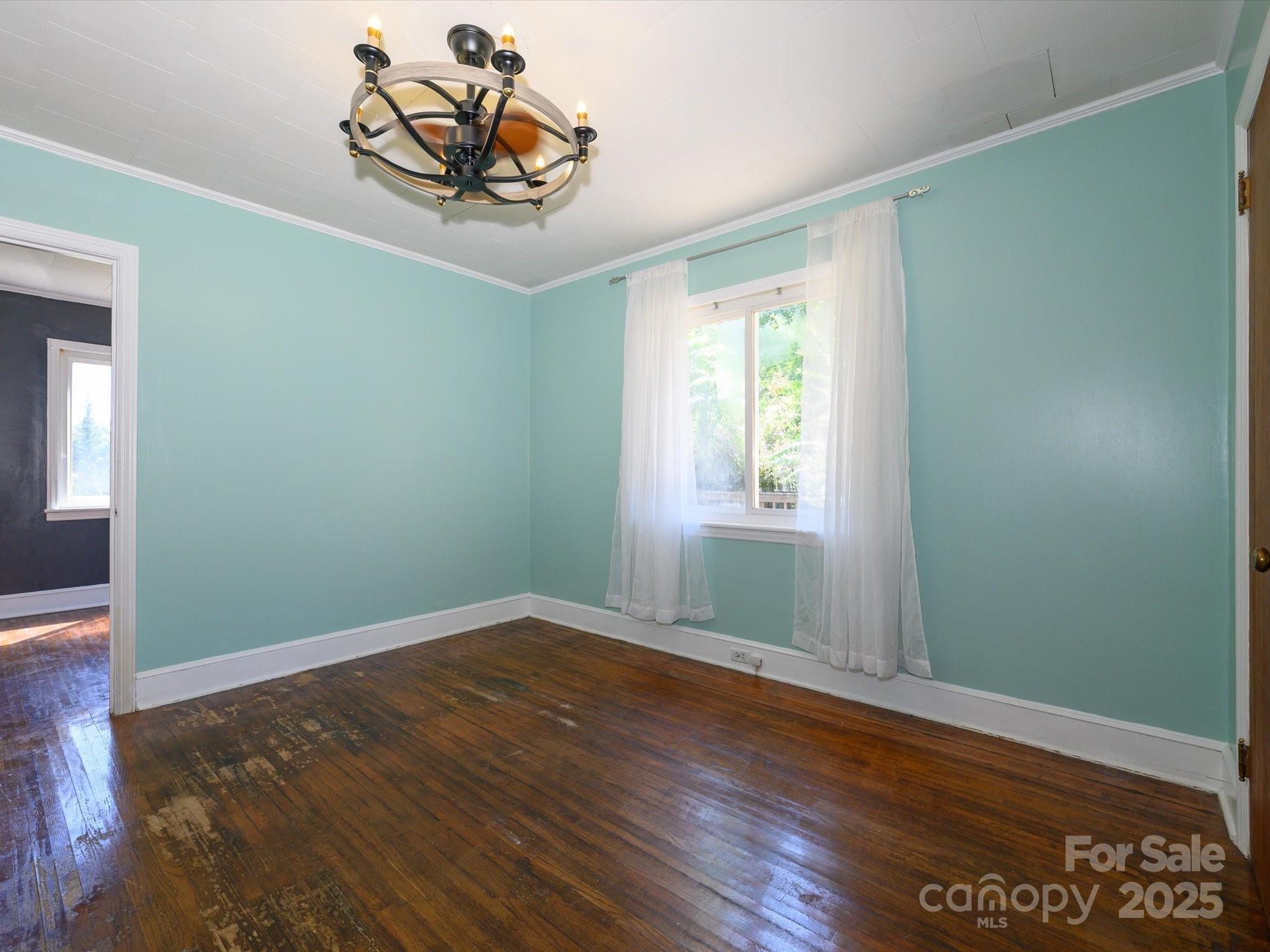 7022 White Store Road Marshville, NC 28103 - Photo 18 of 26 an empty room with wooden floor closet and windows