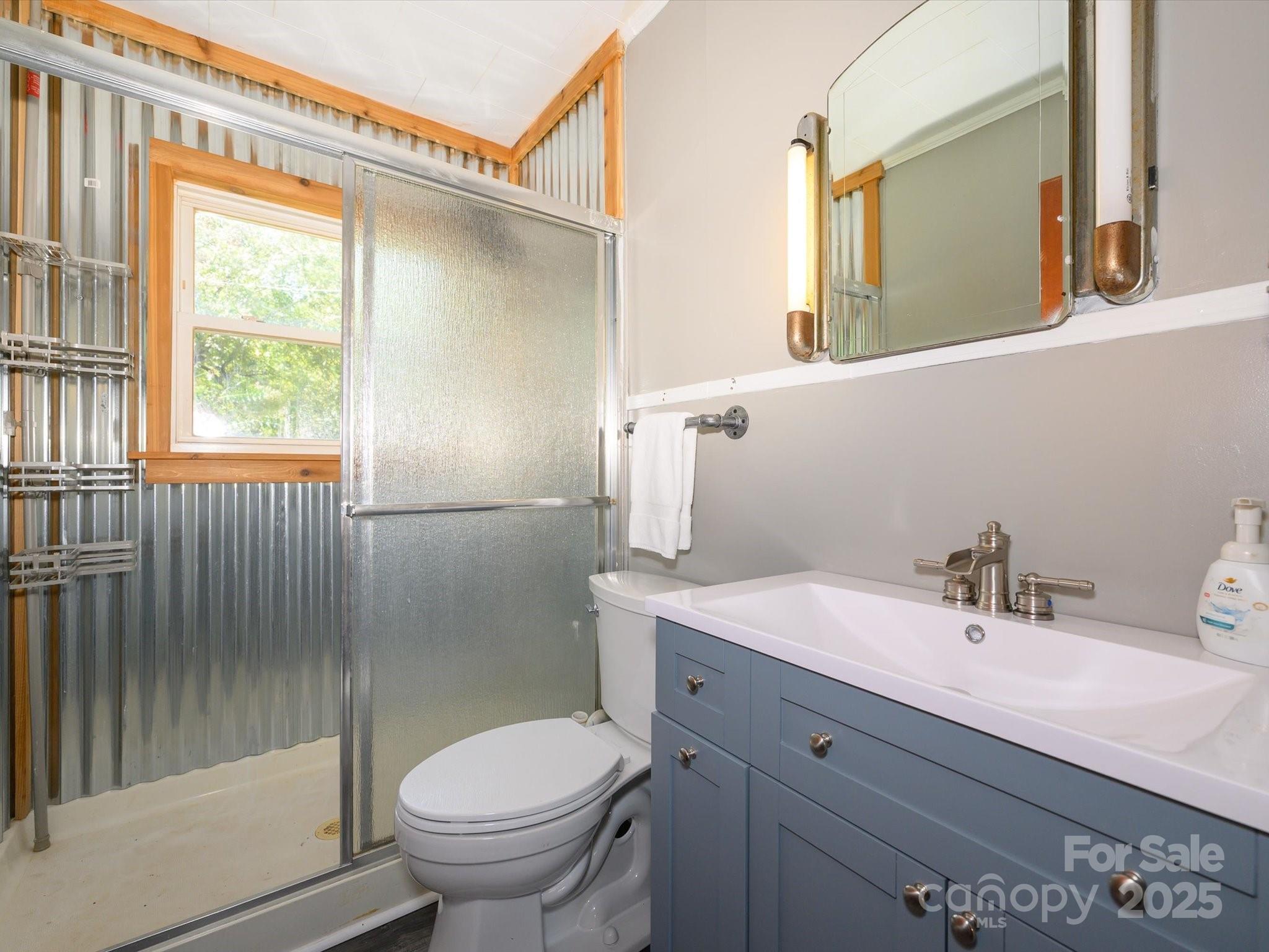 7022 White Store Road Marshville, NC 28103 - Photo 21 of 26 a bathroom with a sink toilet and shower