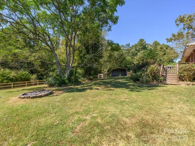 a view of a backyard with swimming pool