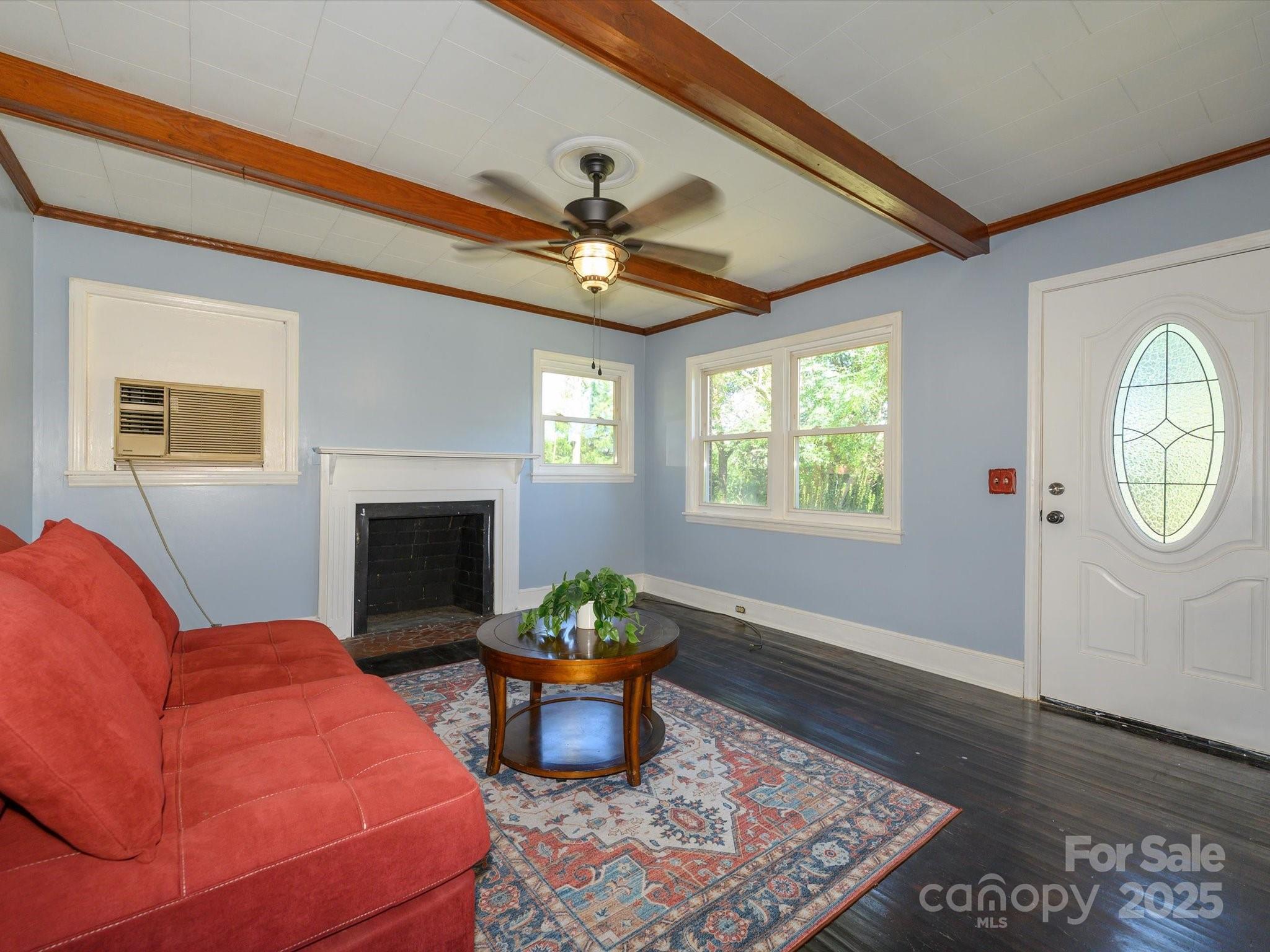 7022 White Store Road Marshville, NC 28103 - Photo 5 of 26 a living room with furniture a chandelier and a fireplace