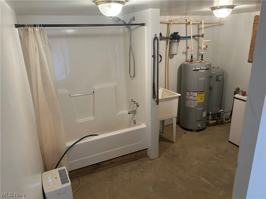 50748 Shenandoah Road Caldwell, OH 43724 - Photo 34 of 43 Utility room featuring electric water heater and a tub combo