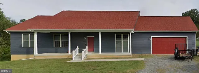 a front view of a house with a garden and porch