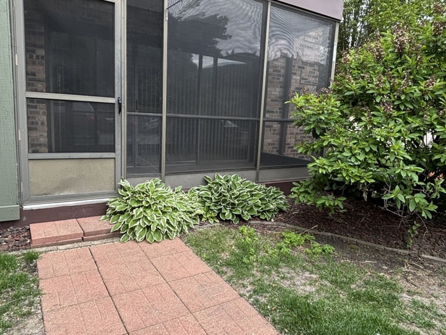9168 S Road, Unit A Palos Hills, IL 60465 - Photo 11 of 14 a flower garden with a glass door