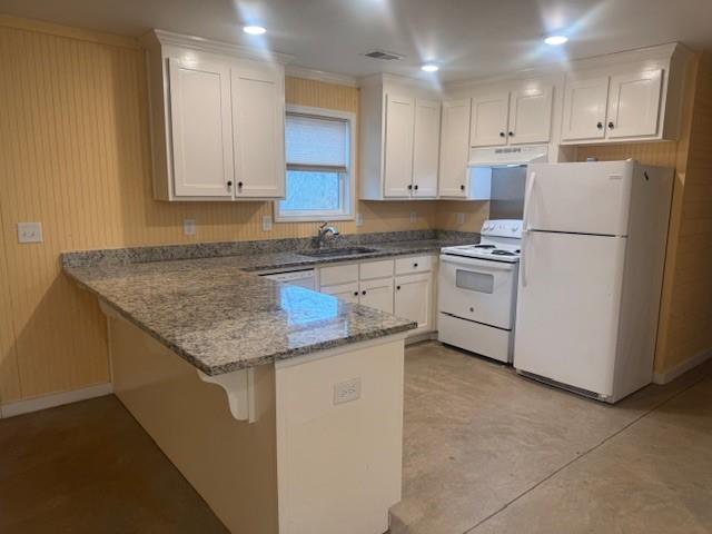 5376 Archer Avenue Cumming, GA 30041 - Photo 6 of 16 a kitchen with granite countertop white cabinets and white appliances