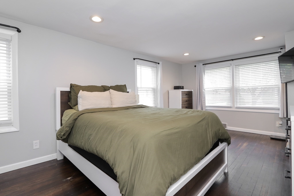 114 Davis Street Springfield, MA 01104 - Photo 15 of 42 a bed sitting in a spacious bedroom next to a window