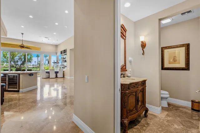 a spacious bedroom with a bed a fireplace and a flat screen tv