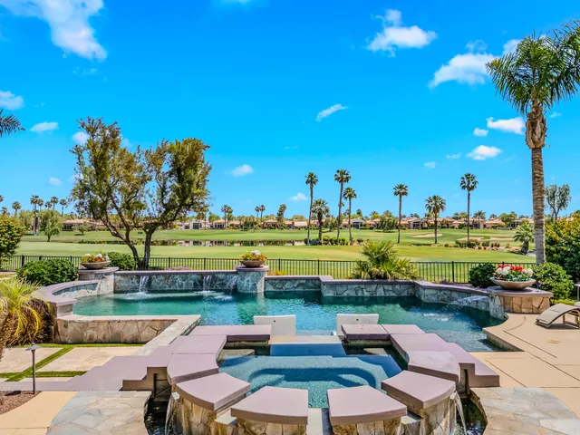 a view of a dining room with furniture large window and kitchen view
