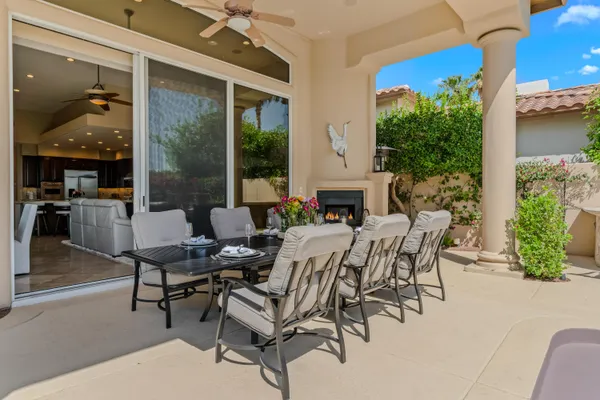 a view of a house with yard and sitting area