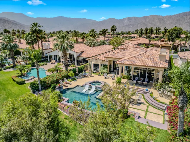 an aerial view of a house with a garden and trees