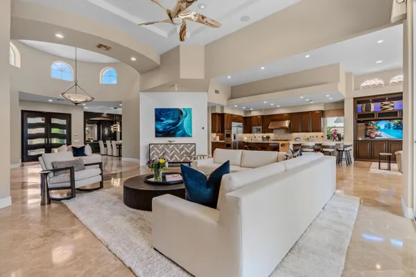 a living room with furniture and a chandelier