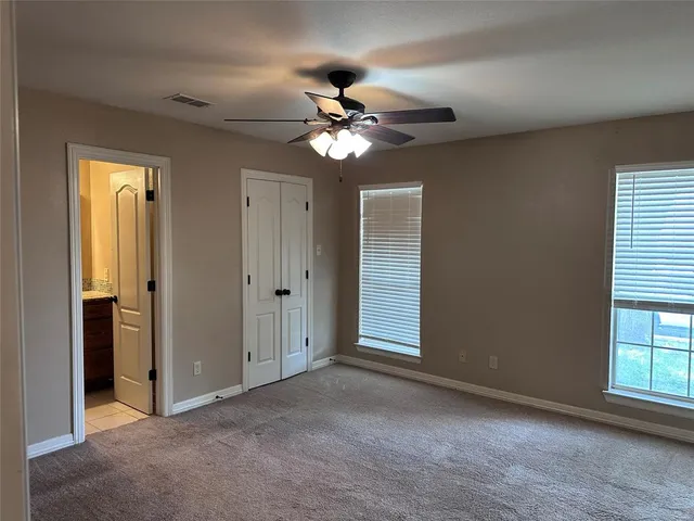 a view of a hallway with wooden floor and a living room