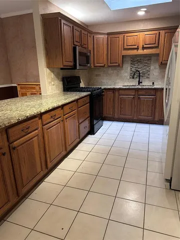 a kitchen with stainless steel appliances granite countertop a sink and cabinets