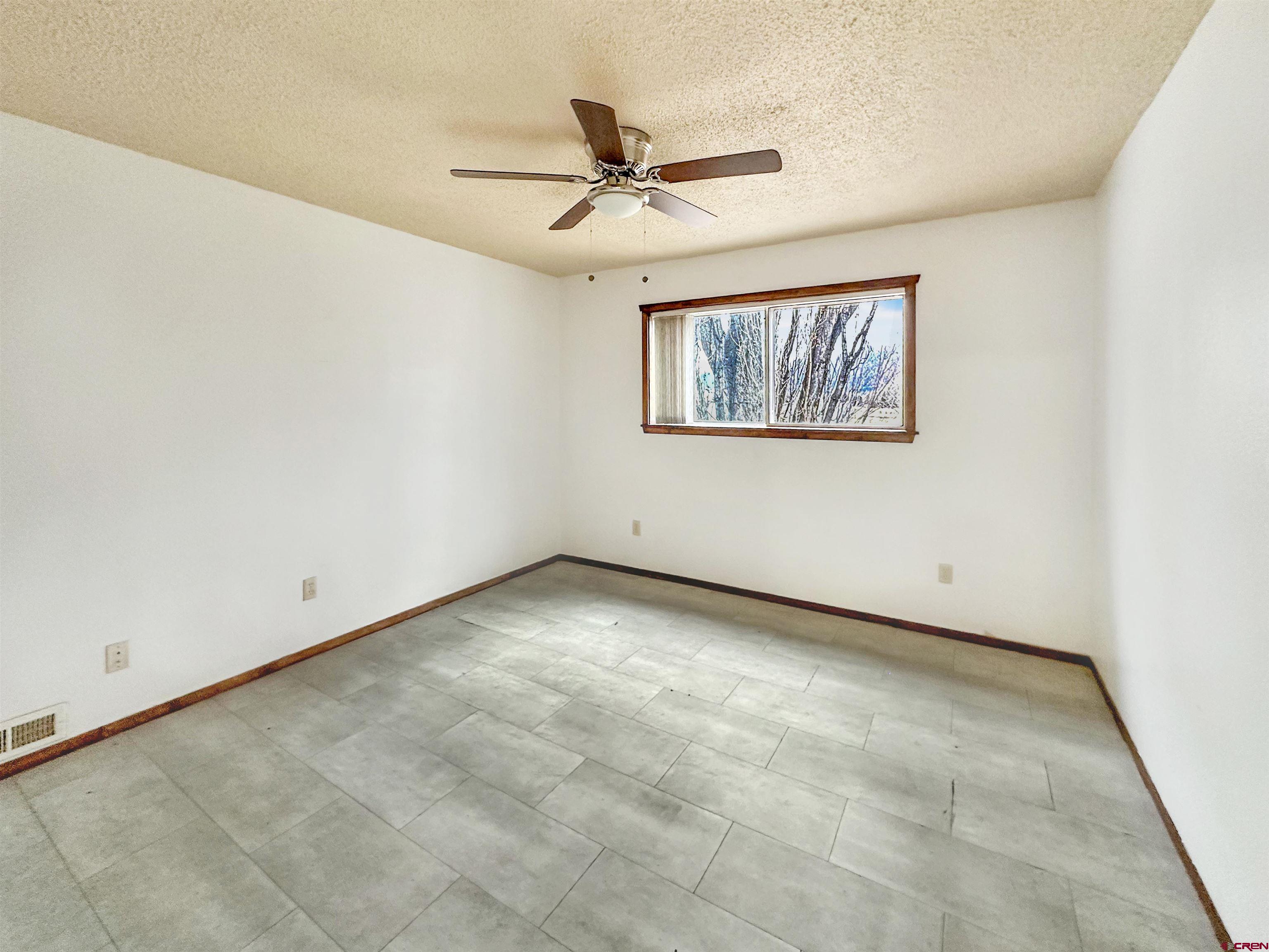 6644 County Road 203 Durango, CO 81301 - Photo 13 of 21 an empty room with a ceiling fan and a window
