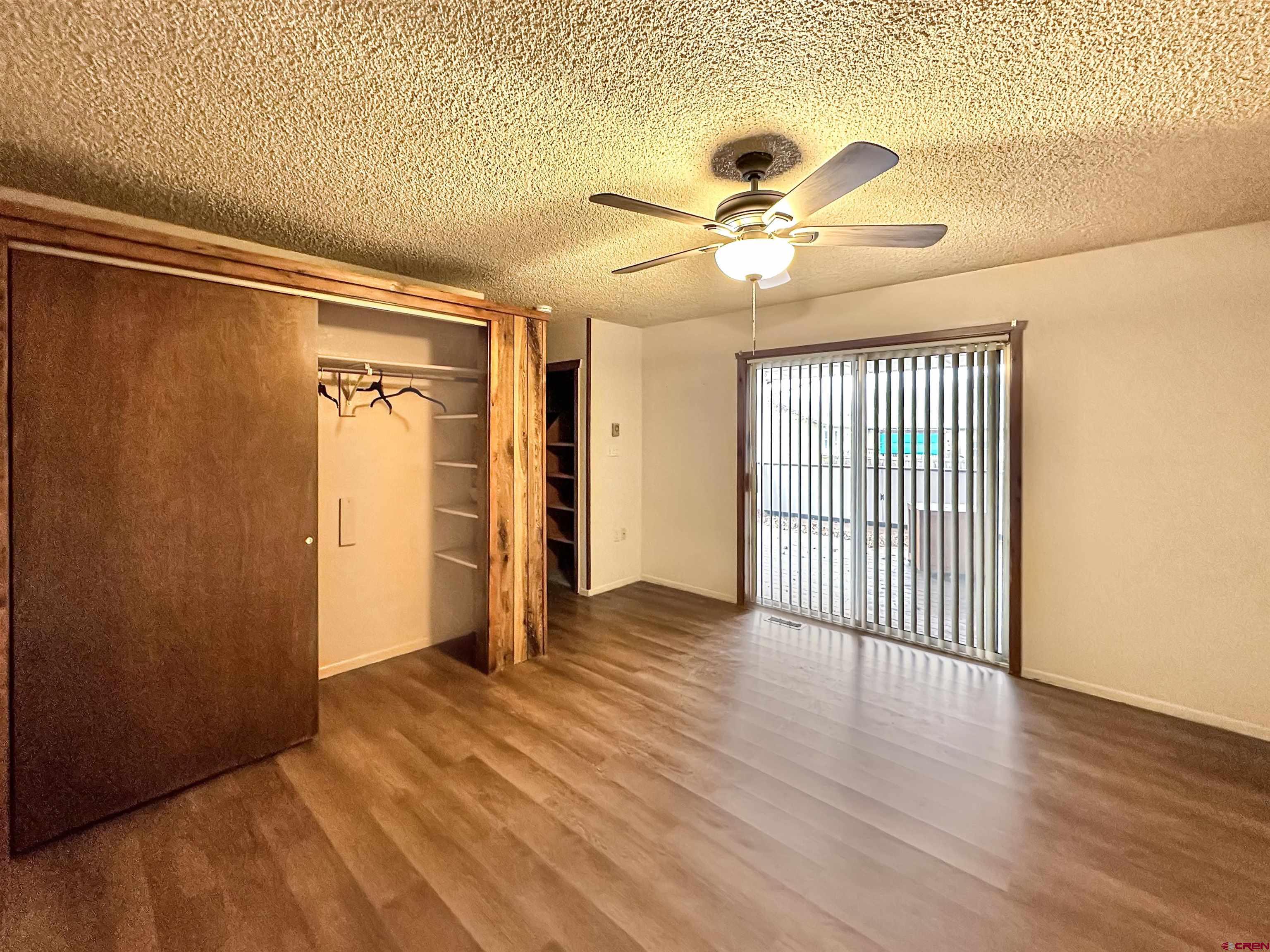 6644 County Road 203 Durango, CO 81301 - Photo 16 of 21 a view of an empty room with wooden floor and a ceiling fan