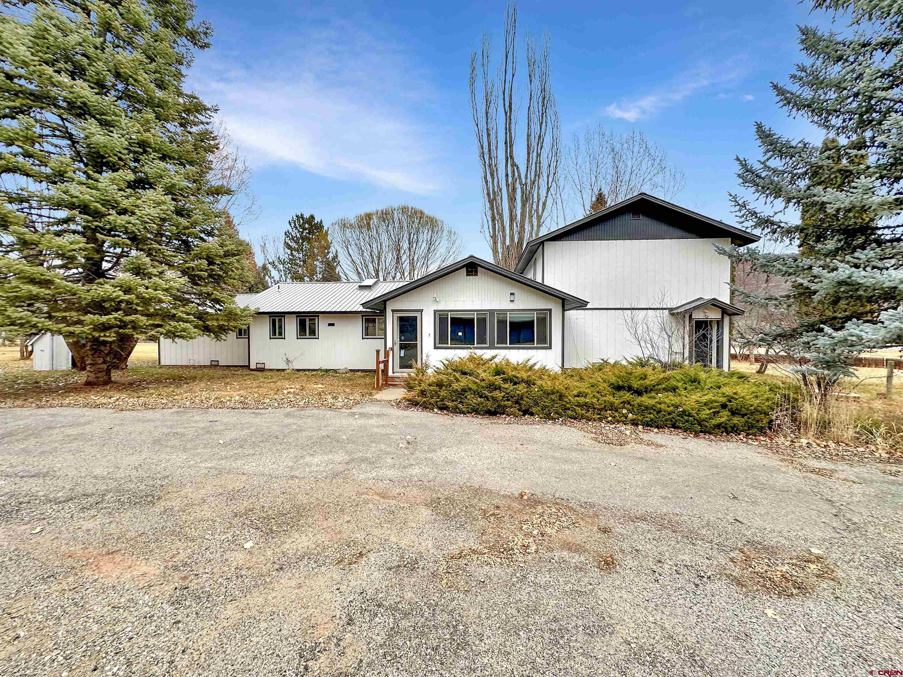 6644 County Road 203 Durango, CO 81301 - Photo 2 of 21 a front view of a house with a yard and garage
