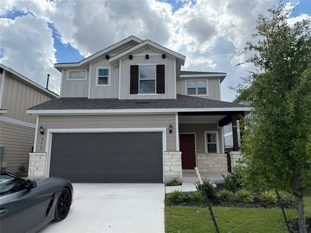 a front view of a house with a yard and garage