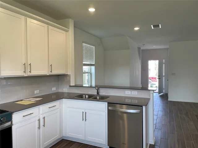 a kitchen with a sink and cabinets