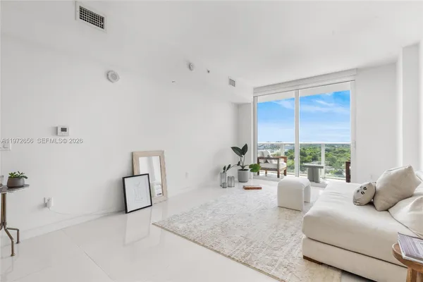 a living room with furniture and a large window
