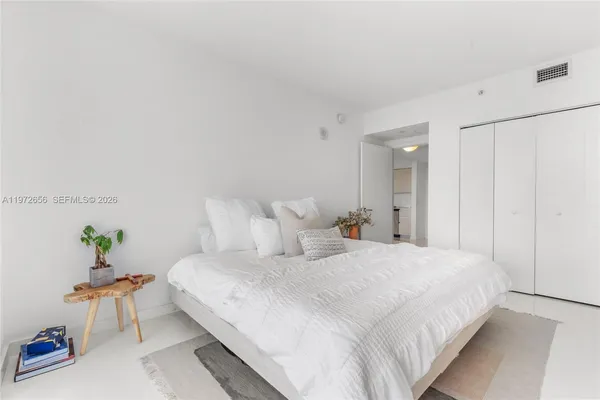 a bedroom with a bed and a table