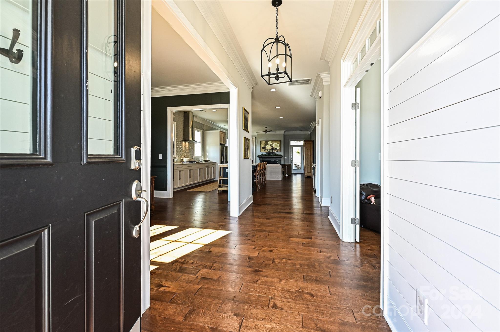 570 Crawfish Drive Fort Mill, SC 29708 - Photo 3 of 37 a view of a hallway with wooden floor and a livingroom with furniture
